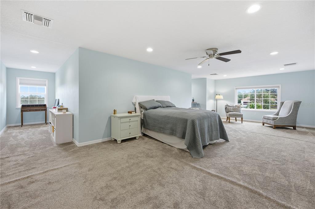 5608 Strong Point Weirsdale, FL 32195 - Photo 49 of 56 a spacious bedroom with a bed and furniture