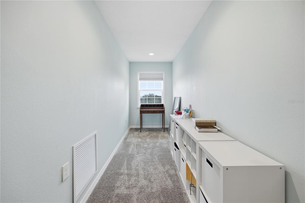 5608 Strong Point Weirsdale, FL 32195 - Photo 50 of 56 a view of hallway with washer and dryer