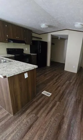 a kitchen with stainless steel appliances wooden cabinets and a granite counter top