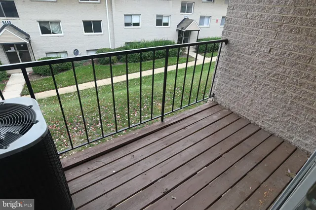 a view of a balcony with wooden floor