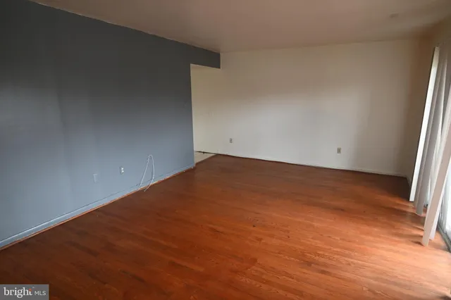 an empty room with wooden floor