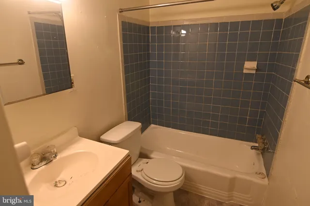a bathroom with a sink a toilet and bathtub