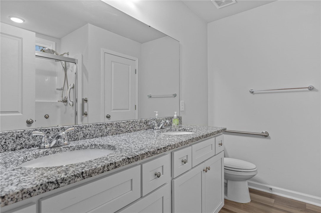 24 Chalet Court Anderson, SC 29621 - Photo 18 of 39 This modern bathroom features a dual vanity with ample storage and a sleek shower.