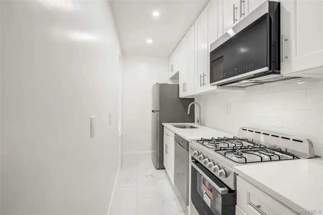 a stove top oven sitting inside of a kitchen