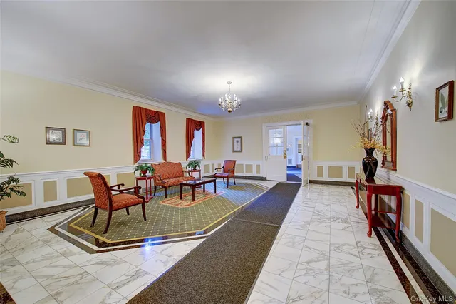 a living room with furniture a flat screen tv and a rug