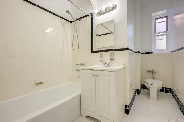 a kitchen with a sink a refrigerator and cabinets