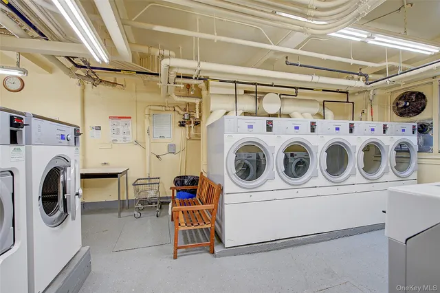 a living room with furniture a flat screen tv and a table
