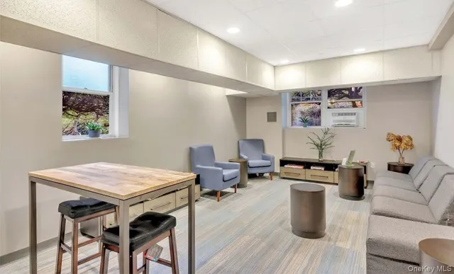 a view of a building with a yard and sitting area