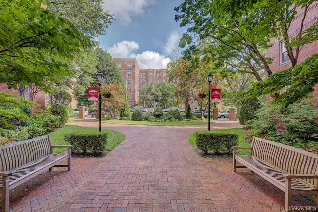 a view of a street with benches in the background