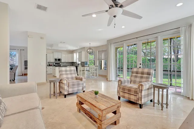 a living room with furniture and floor to ceiling windows