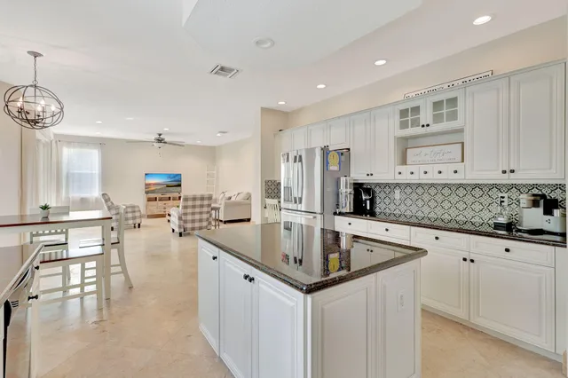 a kitchen with stainless steel appliances granite countertop a sink and cabinets