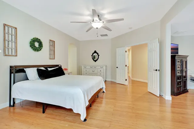 a bedroom with a bed and a chandelier