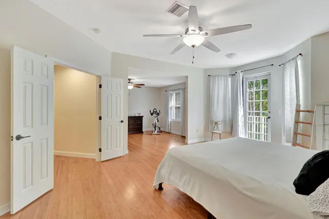 a spacious bedroom with a large bed closet and a window