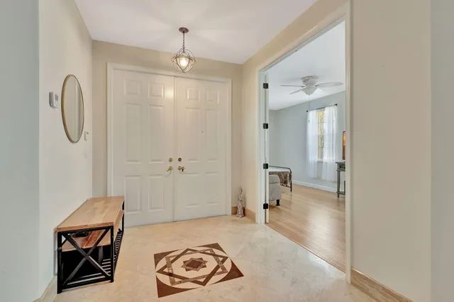 a spacious bathroom with a toilet a sink and mirror