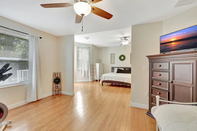 a bedroom with furniture and a wooden floor