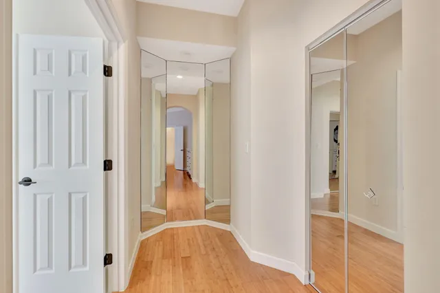 a view of a hallway with wooden floor and entryway