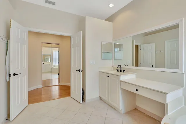 a spacious bathroom with a shower sink and mirror