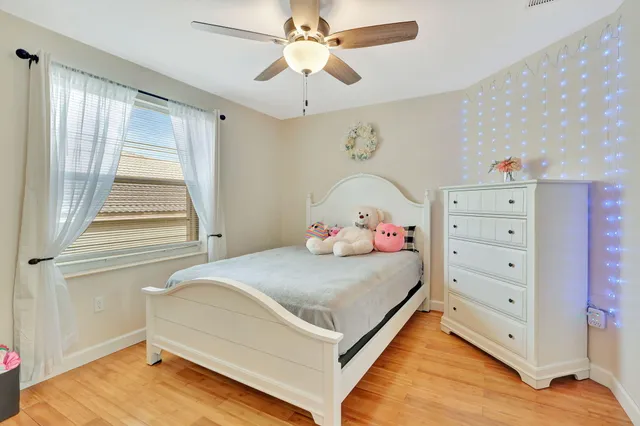 a bedroom with a bed and a chandelier fan