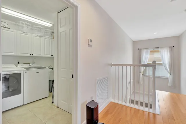 a view of a kitchen with white cabinets