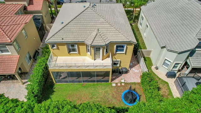 an aerial view of a house with swimming pool and porch