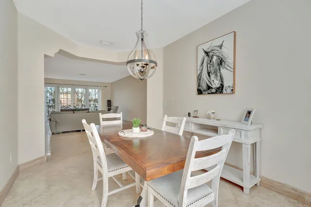 a view of a dining room with furniture and chandelier