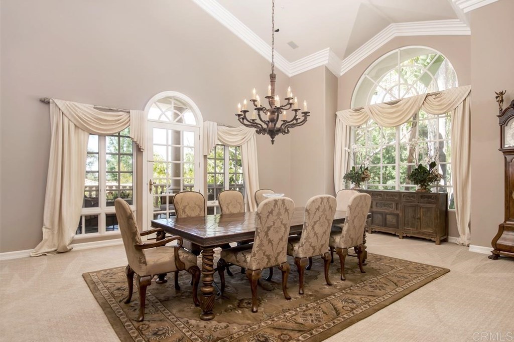 17101 Circa Oriente Rancho Santa Fe, CA 92067 - Photo 12 of 23 a view of a dining room with furniture a chandelier and wooden floor