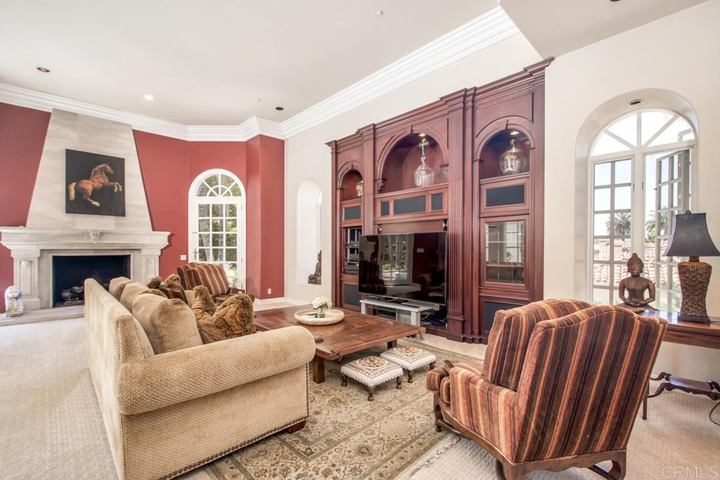 17101 Circa Oriente Rancho Santa Fe, CA 92067 - Photo 14 of 23 a living room with furniture a fireplace and a flat screen tv