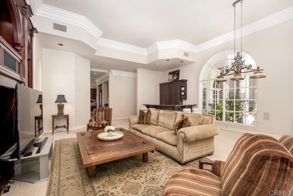 17101 Circa Oriente Rancho Santa Fe, CA 92067 - Photo 15 of 23 a living room with furniture a chandelier and a flat screen tv