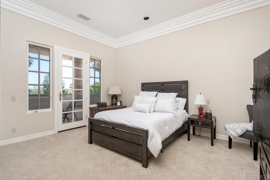 17101 Circa Oriente Rancho Santa Fe, CA 92067 - Photo 22 of 23 a large bedroom with a bed and window