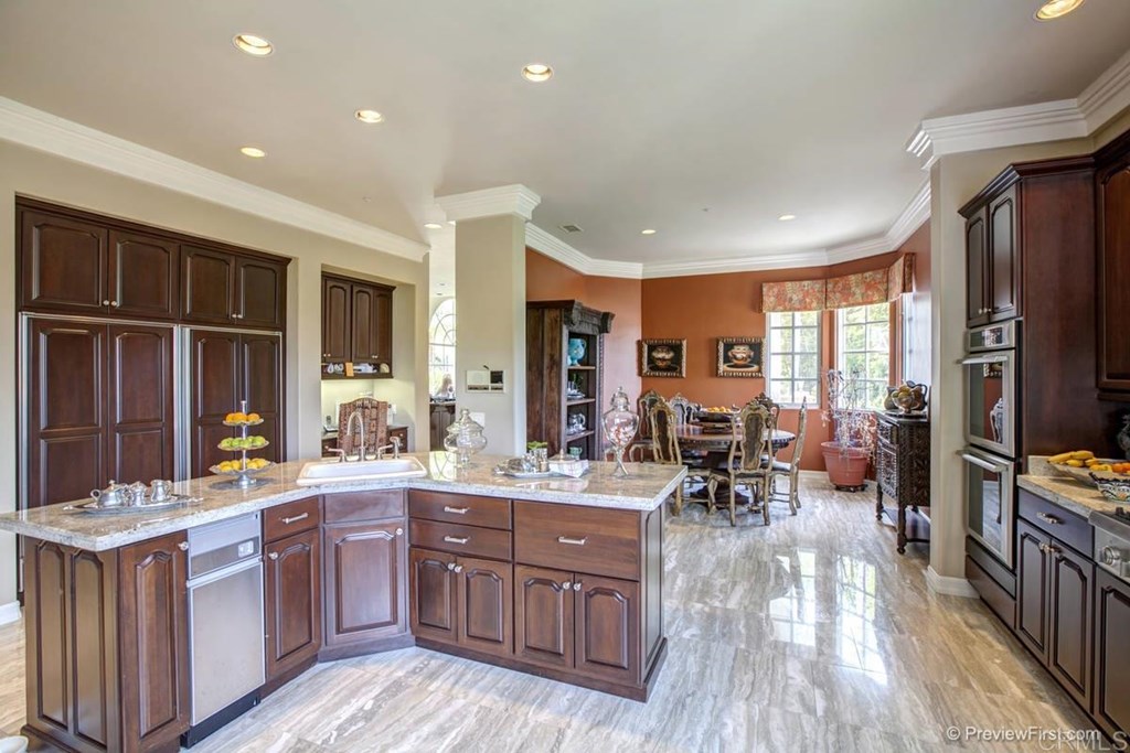 17101 Circa Oriente Rancho Santa Fe, CA 92067 - Photo 7 of 23 a kitchen with stainless steel appliances granite countertop sink stove top oven and cabinets