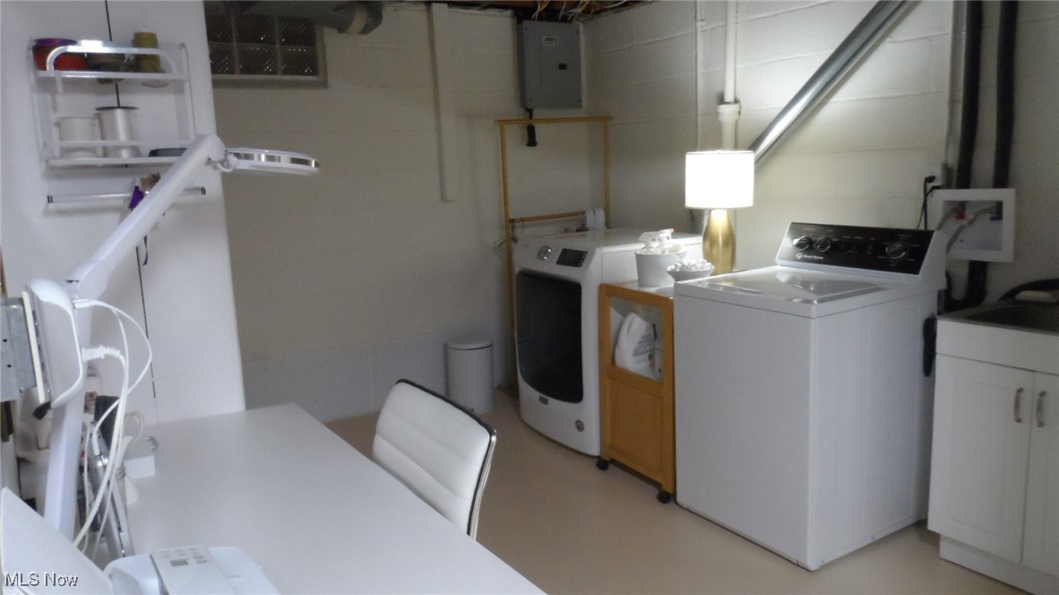 2542 Carson Road Fairlawn, OH 44333 - Photo 22 of 28 :aundry room with electric panel, utility sink and sm office desk washing machine and clothes dryer