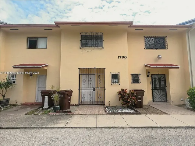 a front view of a house with sitting area