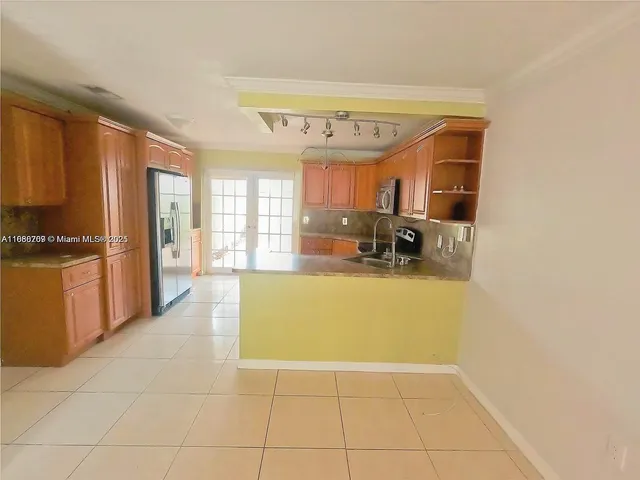 a view of a electric appliances in kitchen and a windows