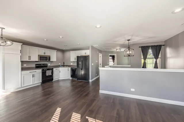 a kitchen with a refrigerator and a sink