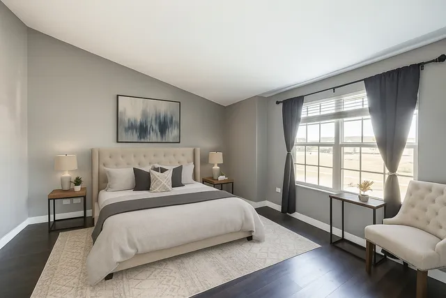 a bedroom with a bed and a couch next to a window