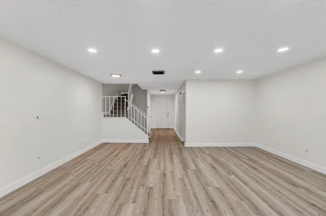 a kitchen with granite countertop a sink stove and cabinets