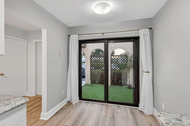 a view of a hallway with wooden floor and entryway