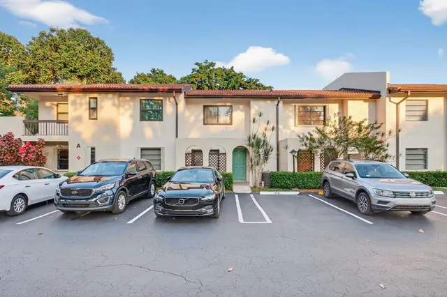 a front view of a house with parking space