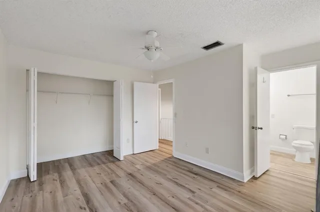 a view of a house with backyard and a tree