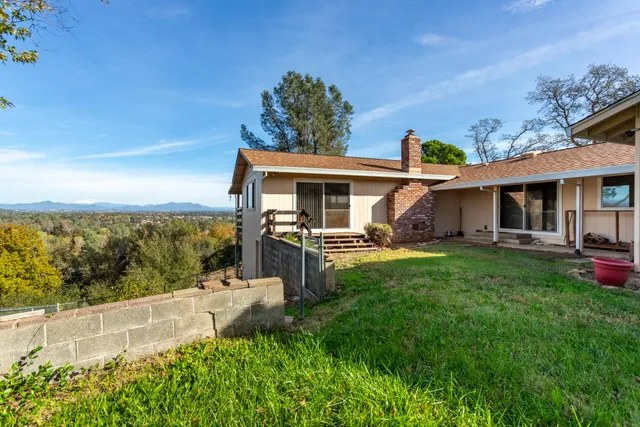 a view of a house with backyard porch and furniture