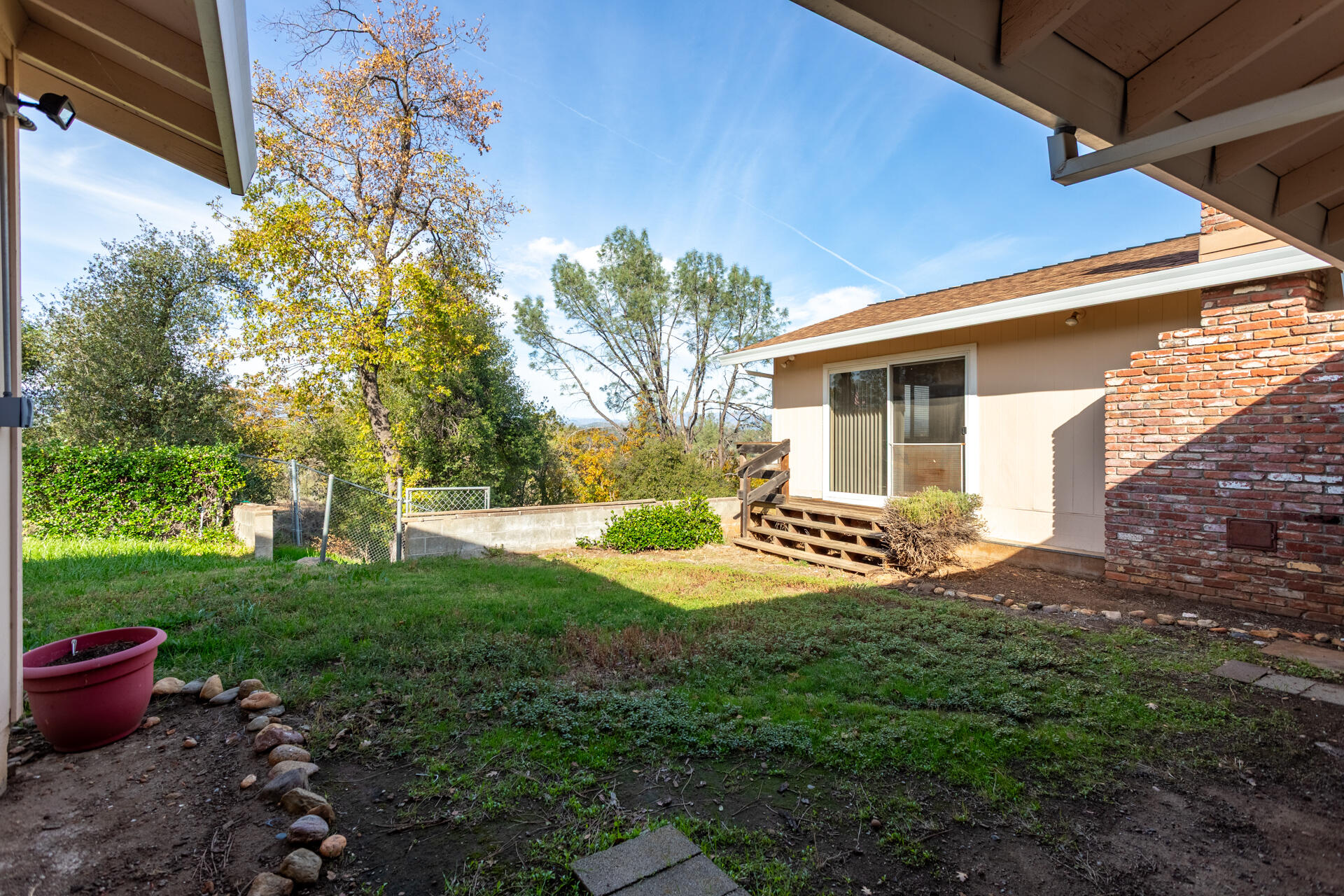 8818 Valley View Road Redding, CA 96001 - Photo 19 of 37 a view of a backyard with table and chairs and potted plants