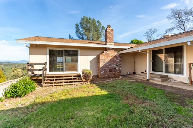 a view of a house with backyard porch and sitting area
