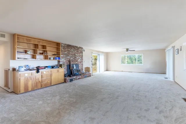 a view of a livingroom with furniture and a window