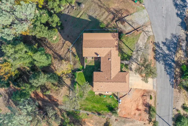 an aerial view of a house with a yard