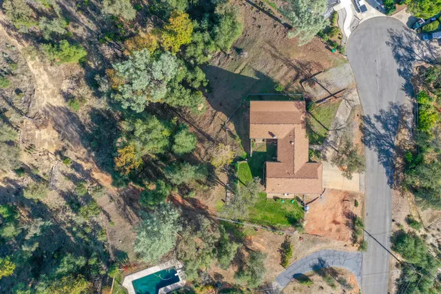 an aerial view of a house with a yard