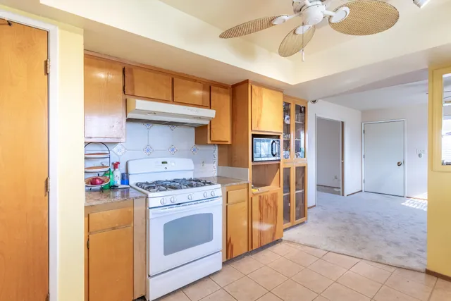 a kitchen with stainless steel appliances granite countertop a stove and a refrigerator