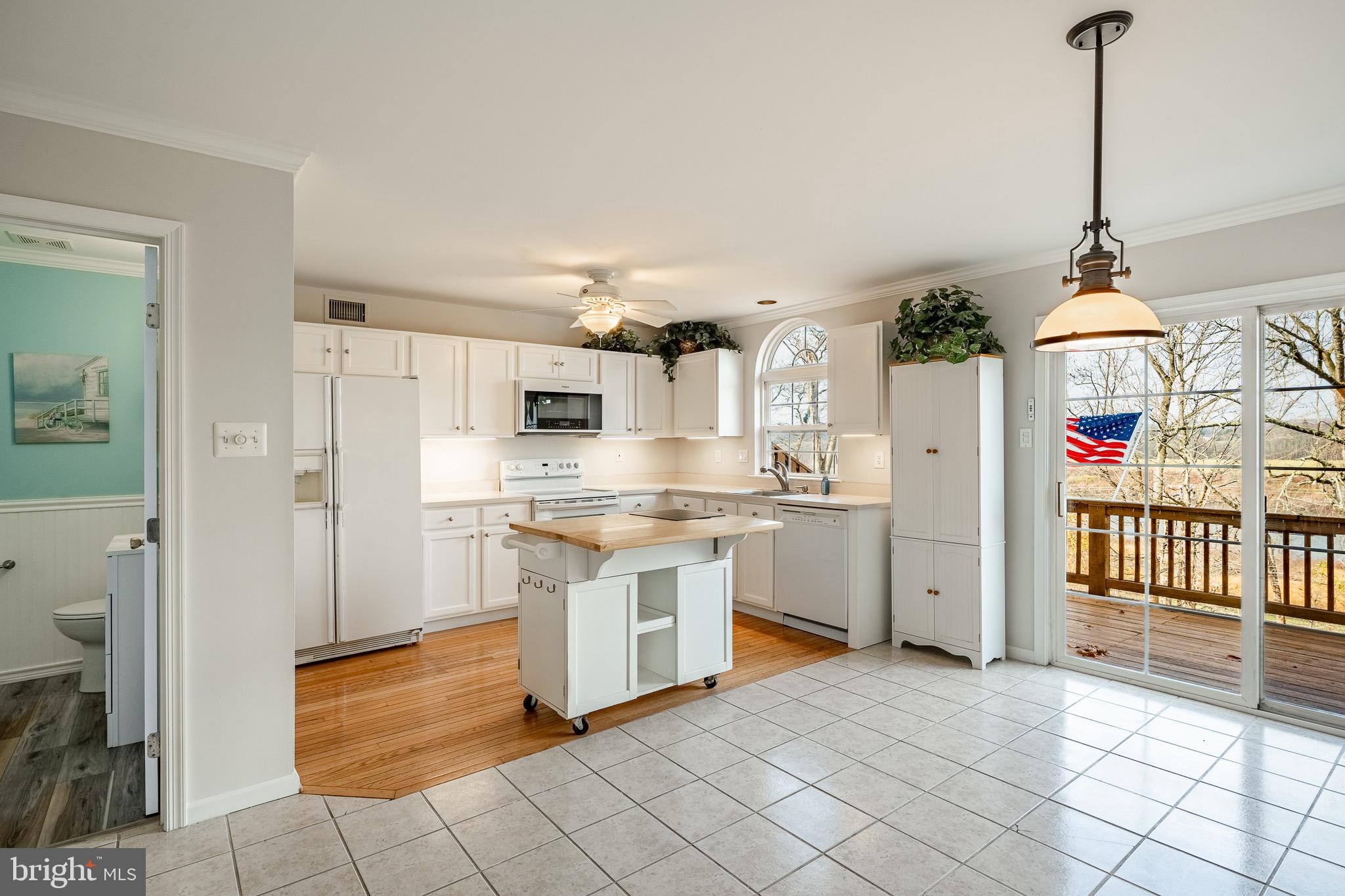 1406 Harbour Ridge Lane Downingtown, PA 19335 - Photo 11 of 57 a open kitchen with white cabinets and white appliances