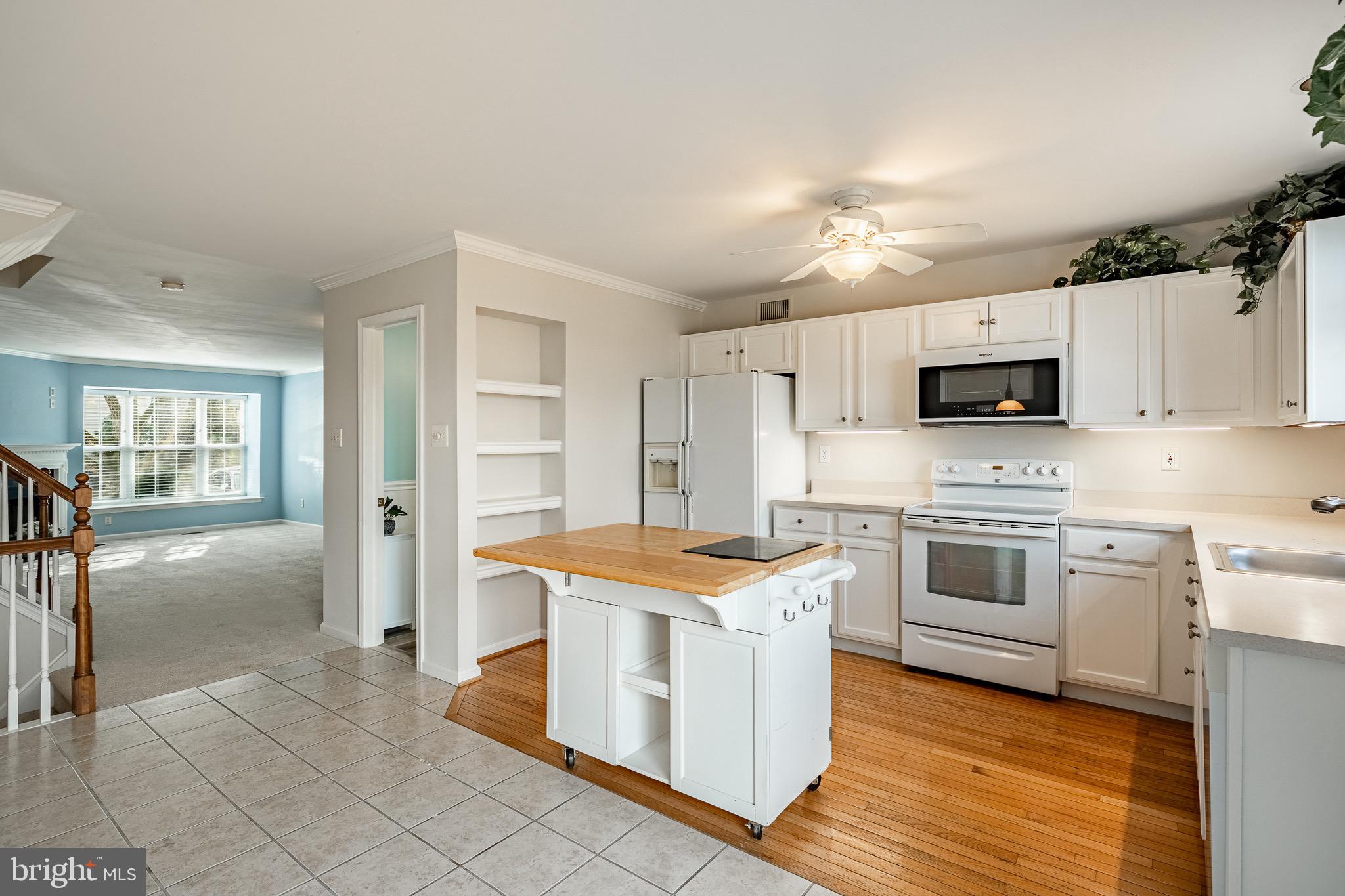 1406 Harbour Ridge Lane Downingtown, PA 19335 - Photo 13 of 57 a kitchen with stainless steel appliances granite countertop a stove top oven a sink dishwasher and a refrigerator with wooden floor
