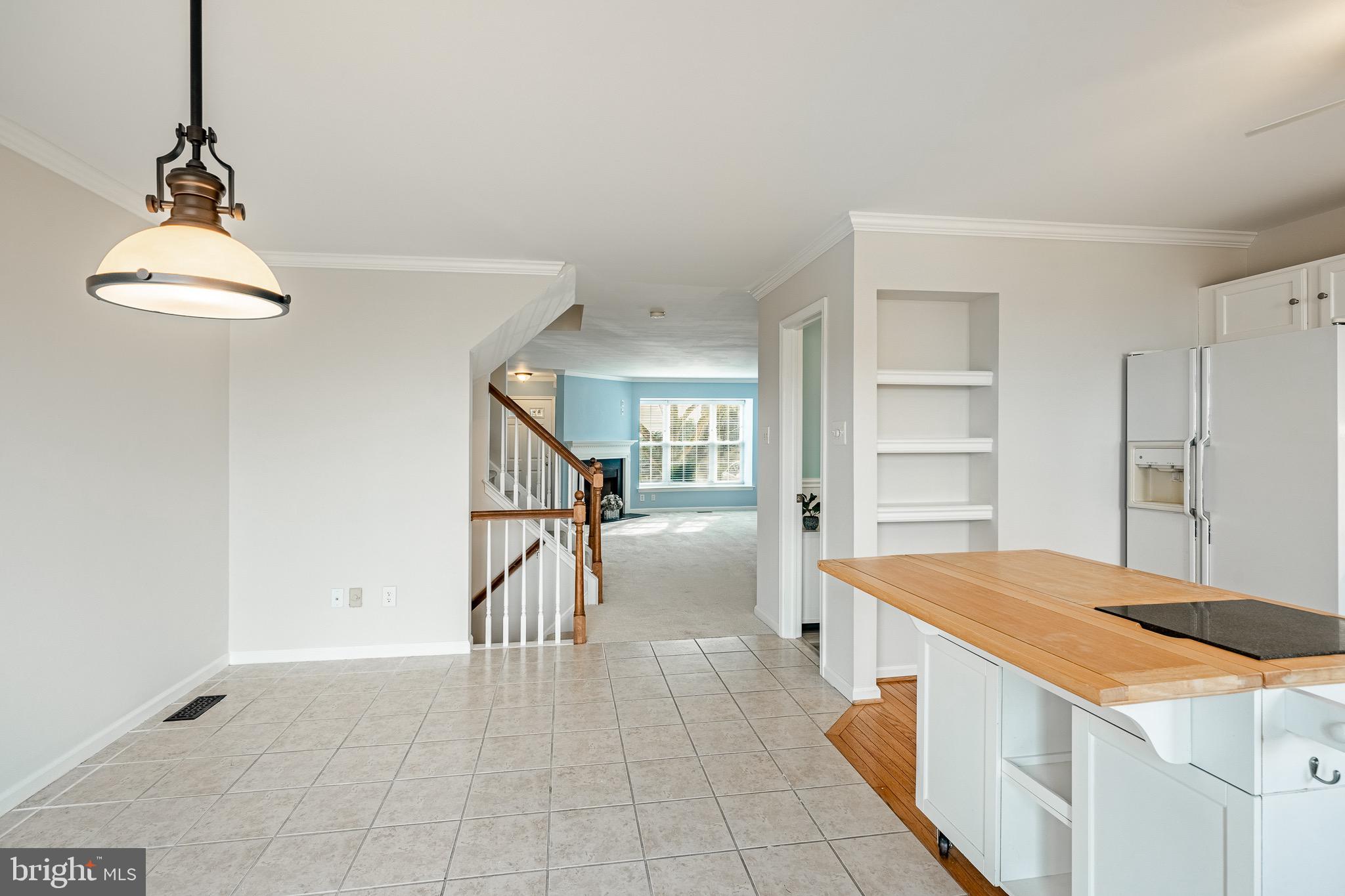 1406 Harbour Ridge Lane Downingtown, PA 19335 - Photo 16 of 57 a kitchen with white cabinets and chandelier