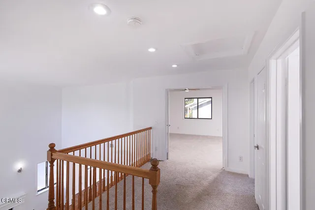 a view of hallway with window and stairs